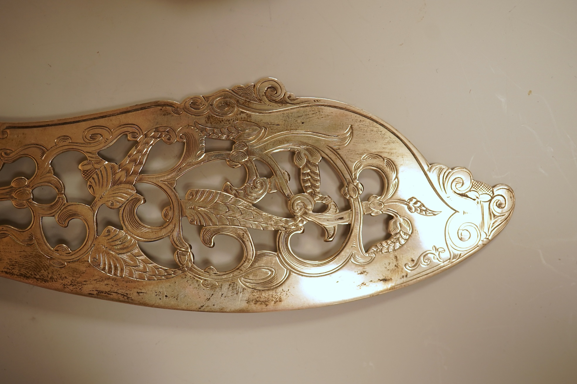 A pair of Victorian ornate silver fish servers, by John Gilbert, Birmingham, 1864, 34.1cm.
